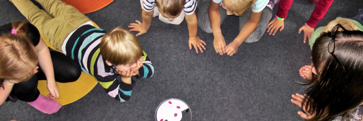 Kinder spielen am Boden